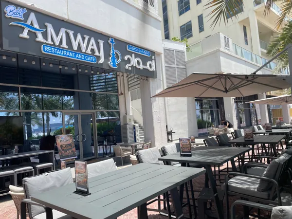 Among the palms · The Amwaj terrace